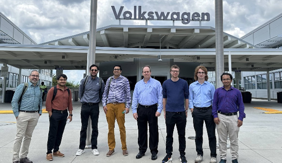 UTK and VW researchers stand in front of the Volkswagen facility in Chattanooga, TN.